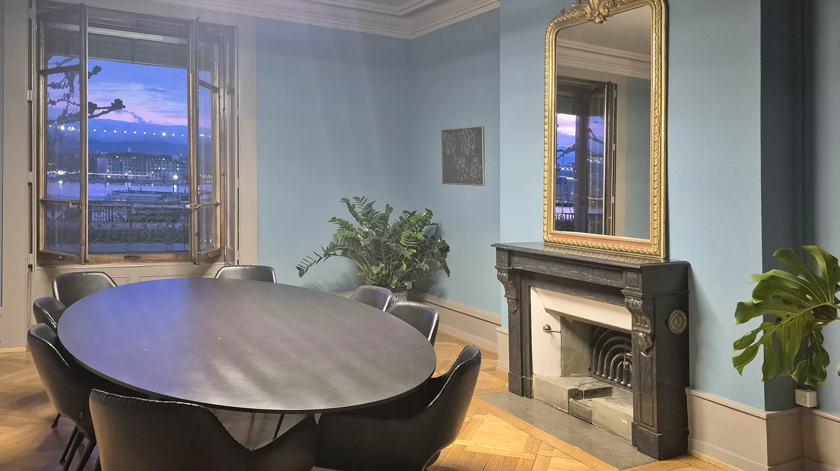 The meeting room at dusk, fireplace and mirror facing the harbour